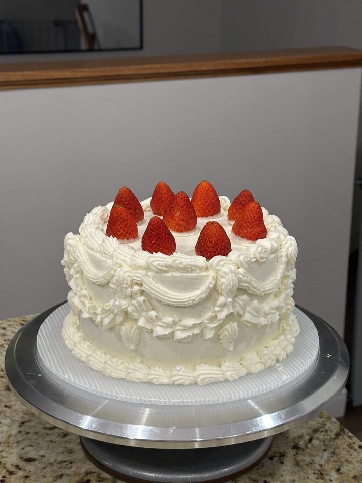 White cake topped with fresh strawberries