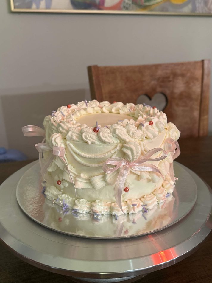 A soft pink vintage cake finished with delicate ribbon bows